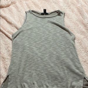 a grey tank top with 2 bottom slits